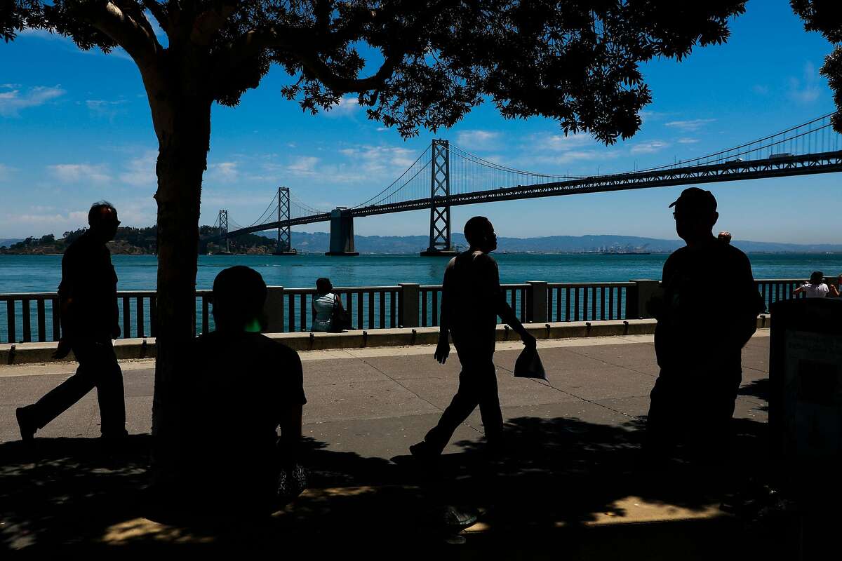 People walk along the Embarcadero in San Francisco, California, on Wednesday, June 12, 2019.
