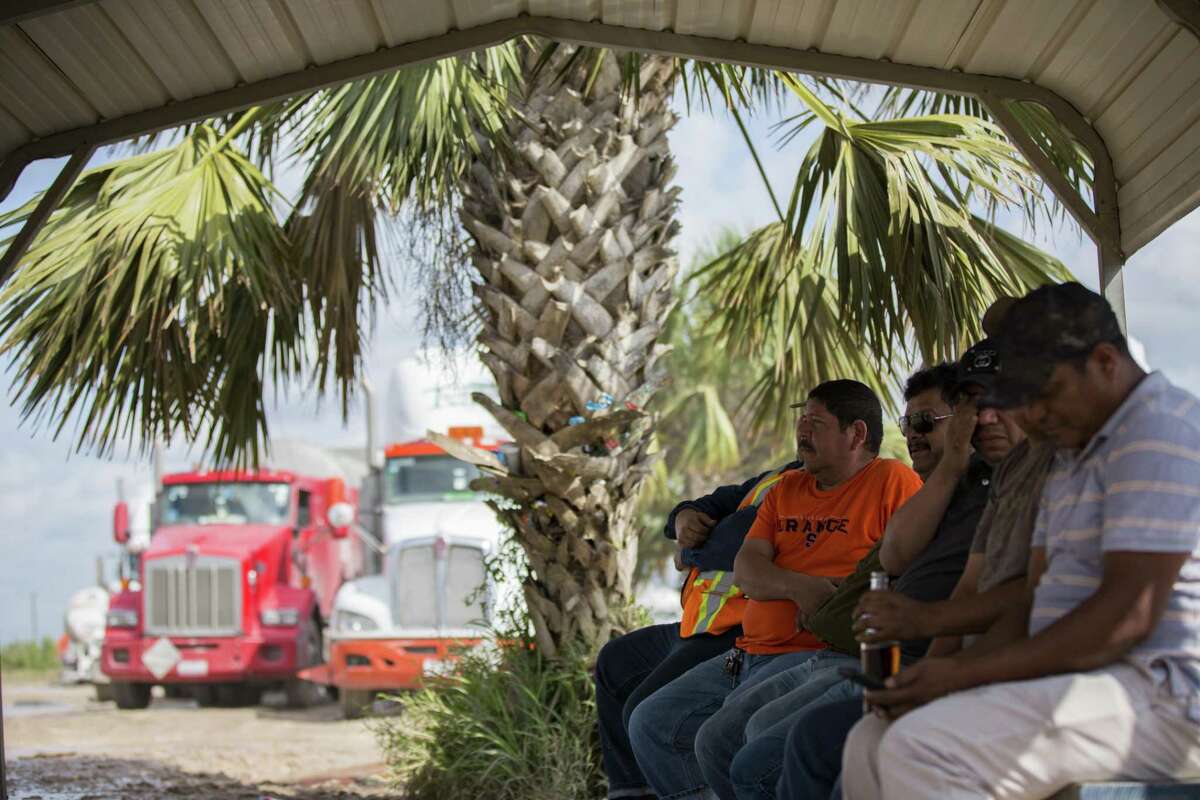 Truckers wait to be able to pick up shipments of motor oil at the receiving area for InterLube at the Port of Brownsville on Friday, March 22, 2019, in Brownsville. Truckers leave Mexico early in the morning and arrive at the port where they wait hours for their shipment and then return south of border. The whole process takes about 14 hours with truckers getting a salary of $45 per day.