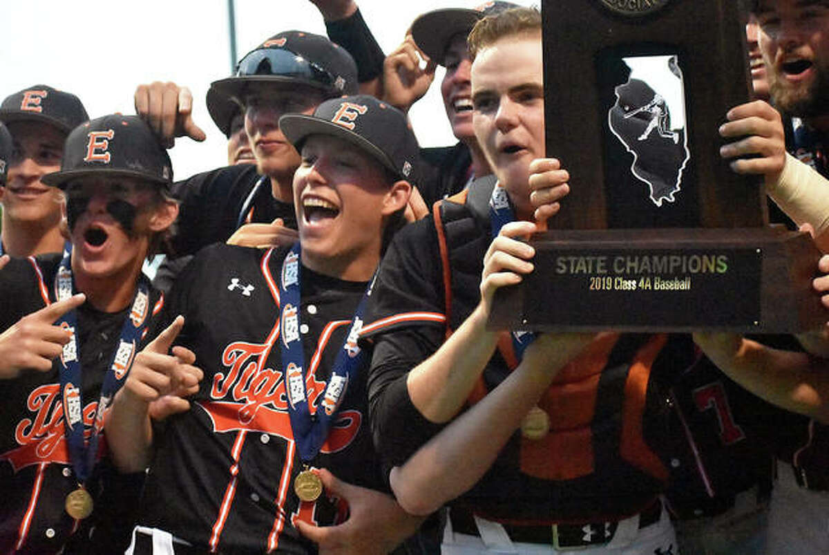 Edwardsville celebrates with the Class 4A state championship trophy after defeating St. Charles North in the title game in Joliet.