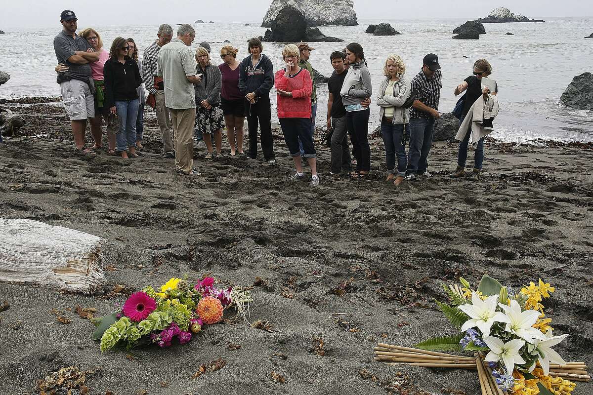 Friends and family of Lindsay Cutshall and her fiance look at the site of their slaying on Friday, Aug. 14, 2014 in Jenner, Calif. Lindsay and her fiance were killed in Jenner ten years ago.