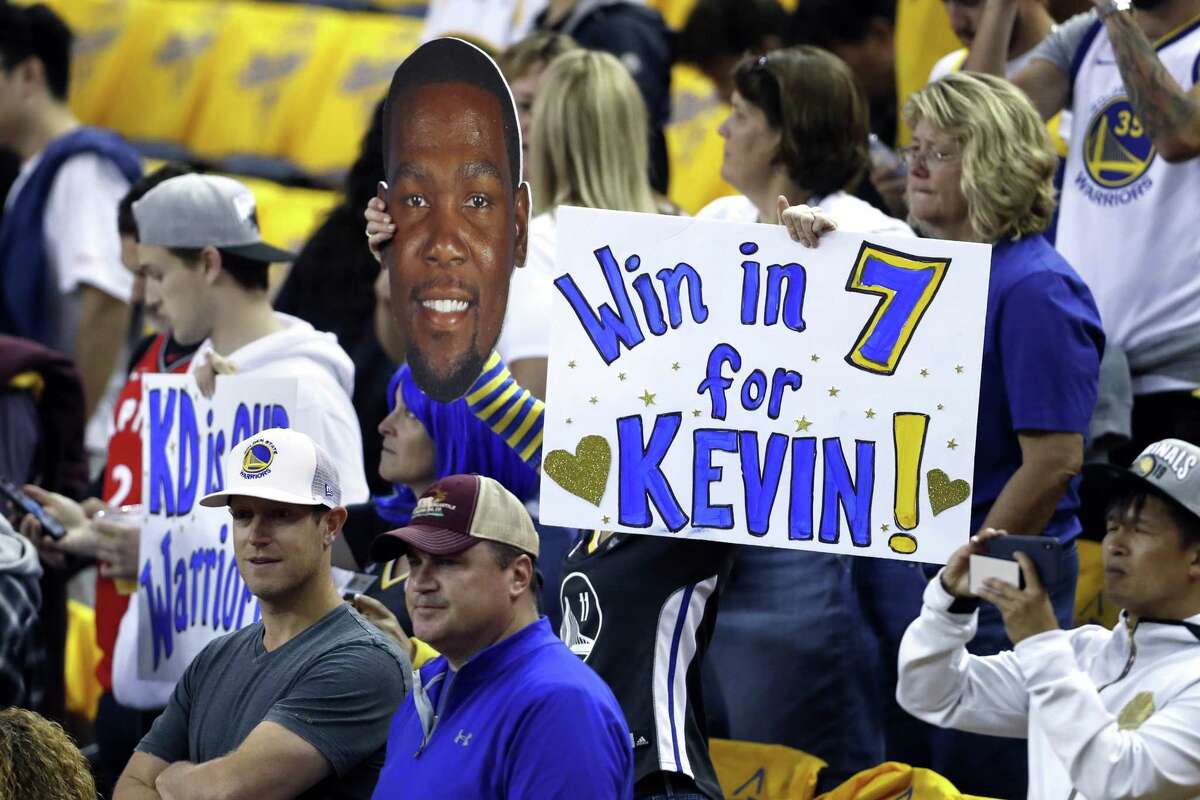 Fans holds signs in support of Kevin Durant.