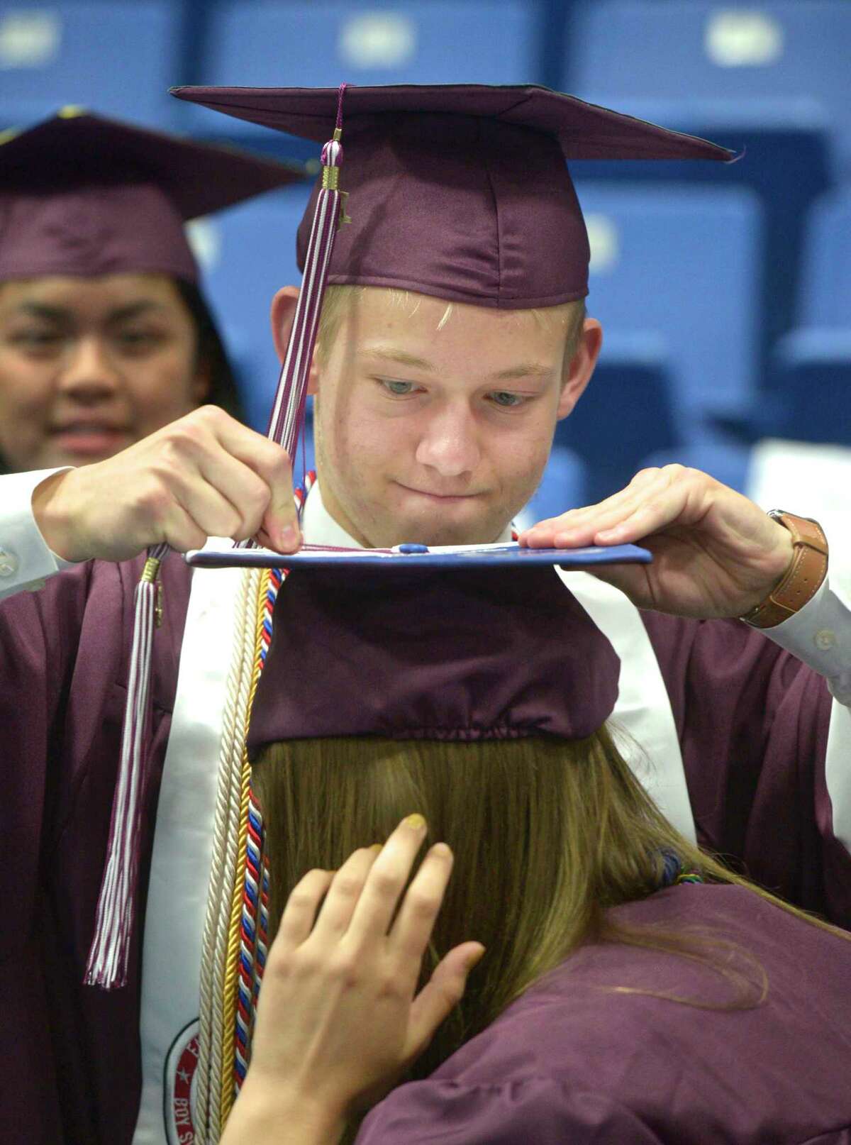 Matthew Evan Canfield makes a last minute adjustment to Veronica Elizabeth Breen's tassel before the Bethel High School Class of 2019 Commencement Ceremony, Thursday June 13, 2019, at the O'Neill Center, Western Connecticut State University, Danbury, Conn.