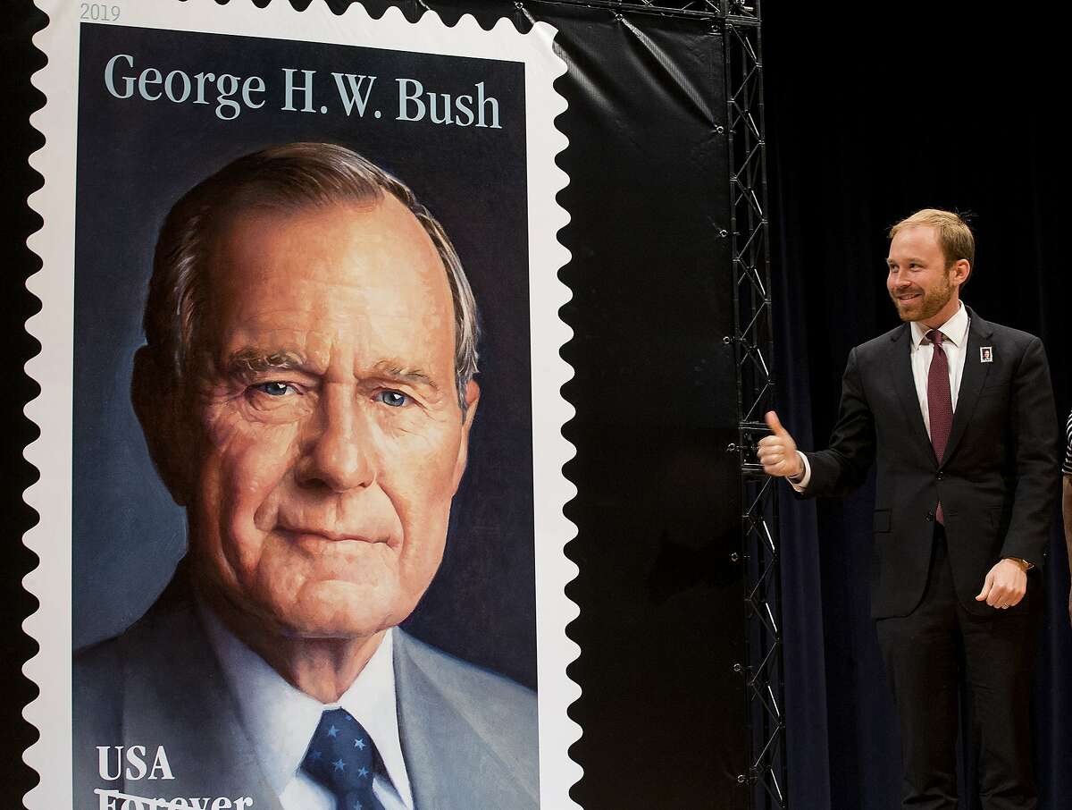 Pierce Bush, grandson of former President George H.W. Bush, gives a thumbs up after the unveiling of the Forever Stamp honoring the 41st President of the United States on Wednesday, June 12, 2019, in College Station, Texas. The first-day-of-issue ceremony coincides with Bush's birthday. The Forever stamp features a portrait of the 41st president painted by award-winning artist Michael J. Deas. (Brett Coomer/Houston Chronicle via AP)