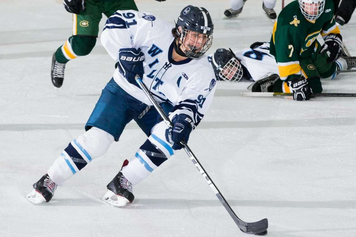 Dean DiNanno rushes the goal during the Wilton boys hockey team's 4-3 win over Trinity Catholic. - GretchenMcMahonPhotography.com