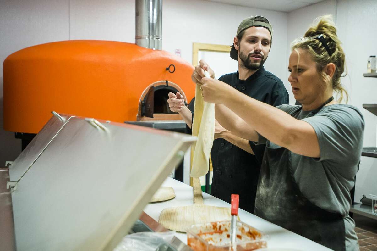 Pizza Baker staff serve free samples while they test a new wood-fired oven on Thursday, June 13, 2019 inside the restaurant at 240 E. Main St. in Midland. No date has been set for the grand opening, but owner Jim Baker is aiming for sometime in mid-July. (Katy Kildee/kkildee@mdn.net)