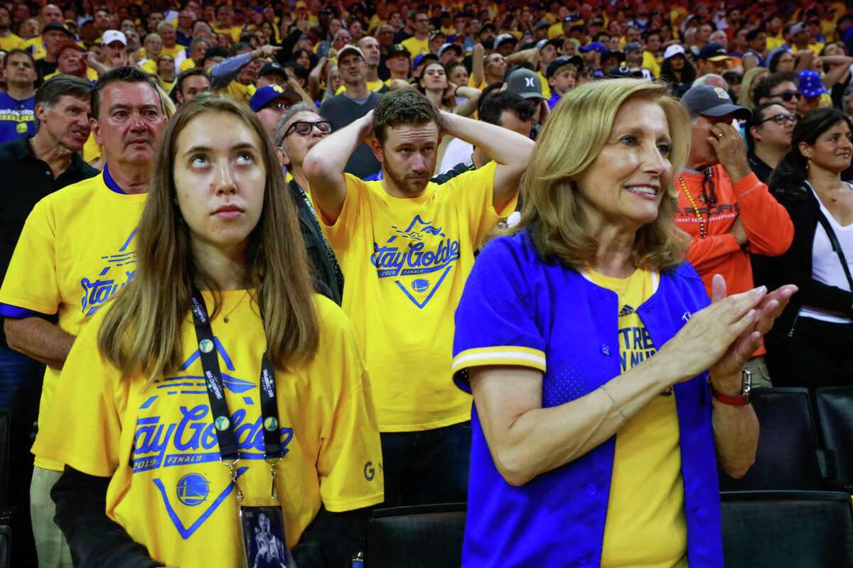People anxiously watch the first half of Game 6 of the NBA Finals between the Golden State Warriors and the Toronto Raptors in Oakland, California, on Thursday, June 13, 2019.