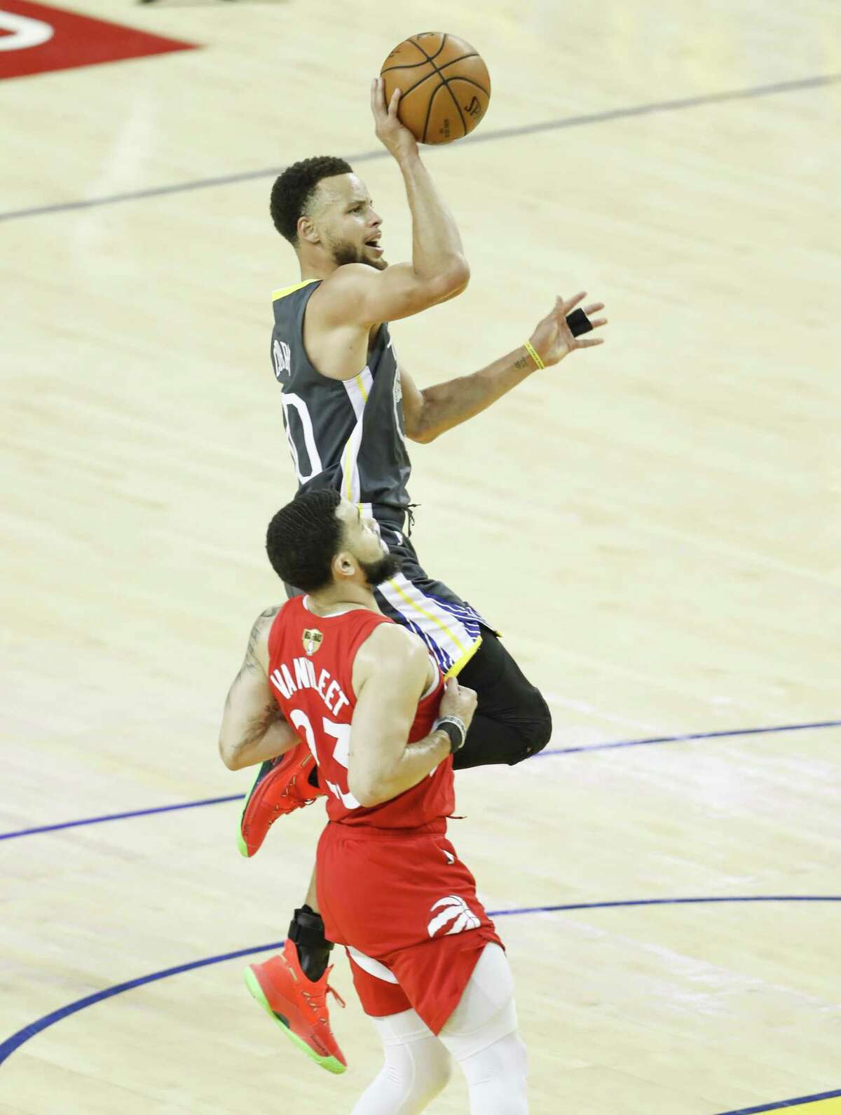 Golden State Warriors’ Stephen Curry shoots over Toronto Raptors’ Fred VanVleet in the third quarter during game 6 of the NBA Finals between the Golden State Warriors and the Toronto Raptors at Oracle Arena on Thursday, June 13, 2019 in Oakland, Calif.