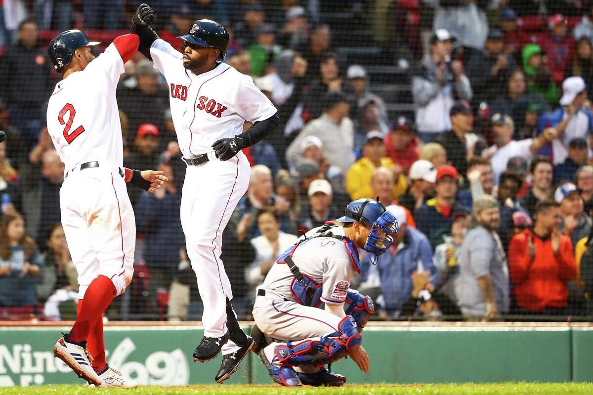 BOSTON, MA - JUNE 13: Jackie Bradley Jr. #19 high fives Xander Bogaerts #2 of the Boston Red Sox after hitting a three-run home run against the Texas Rangers at Fenway Park on June 13, 2019 in Boston, Massachusetts. (Photo by Adam Glanzman/Getty Images)