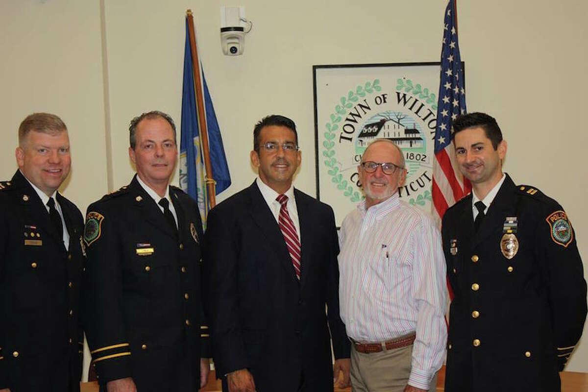 Officer Vincent Penna, center, is joined by, from left, Capt. Thomas Conlan, Chief John Lynch, Police Commission Chair Don Sauvigné, and Capt. Rob Cipolla. — Contributed photo