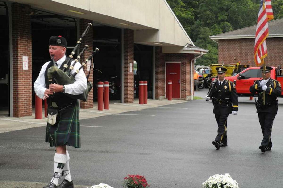 Bagpiper Drew Kennedy leads the procession.