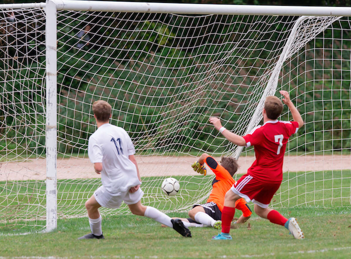 Luke Macdonald deposits Wilton's second goal into the New Canaan net. - GretchenMcMahonPhotography.com