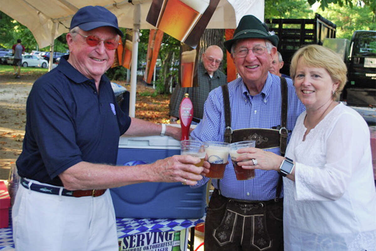 Three Wilton first selectmen — Bill Brennan, left, Paul Hannah, and Lynne Vanderslice — raise a glass of German beer at the Kiwanis Club’s Oktoberfest last year. — Contributed photo