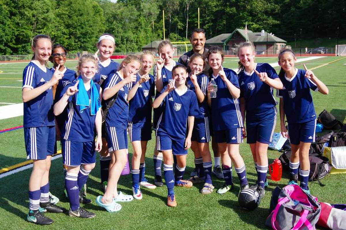 The Wilton Blue U13 girls travel soccer team celebrates its division-clinching win over Monroe on June 17.