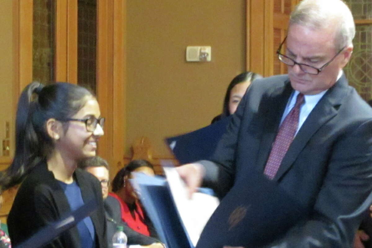 Ria Raniwala receives an award for her presentation at the Oral Kids Court Competition in Hartford on June 12. — Contributed photo