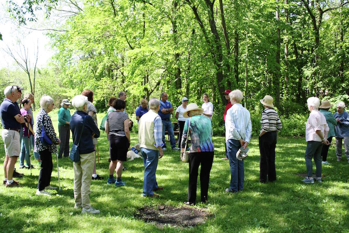 Members of Stay at Home in Wilton listen to land trust executive director Donna Merrill during a walk through Schenck’s Island. — Debbie Louis photo