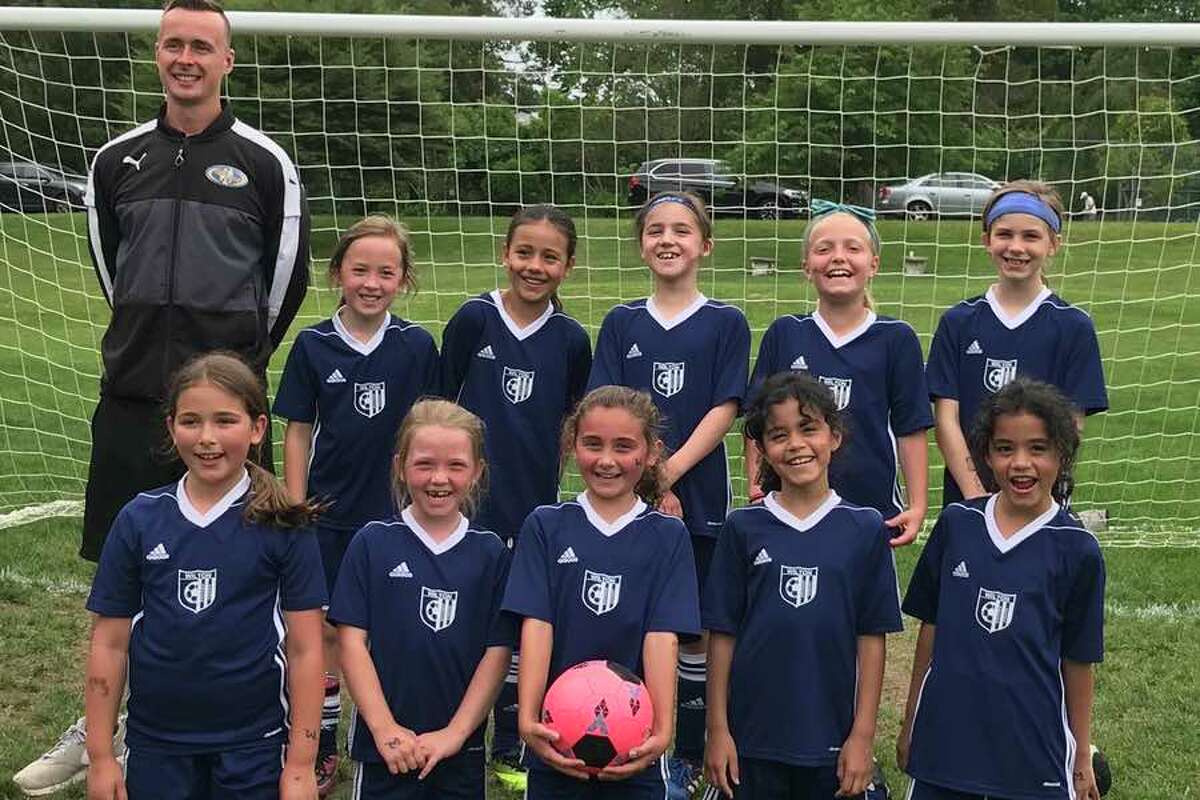 The Wilton White U-9 girls soccer team, from left to right, front: Ashley Pencu, Grayson O’Donnell, Abigail Philippon, Isabella Rios and Sofia Rios; and back: coach Matt Jessup, Gabriella Ray, Gabriela Torres, Mia Timnev, Liesel Schmauch and Harper Crawford.