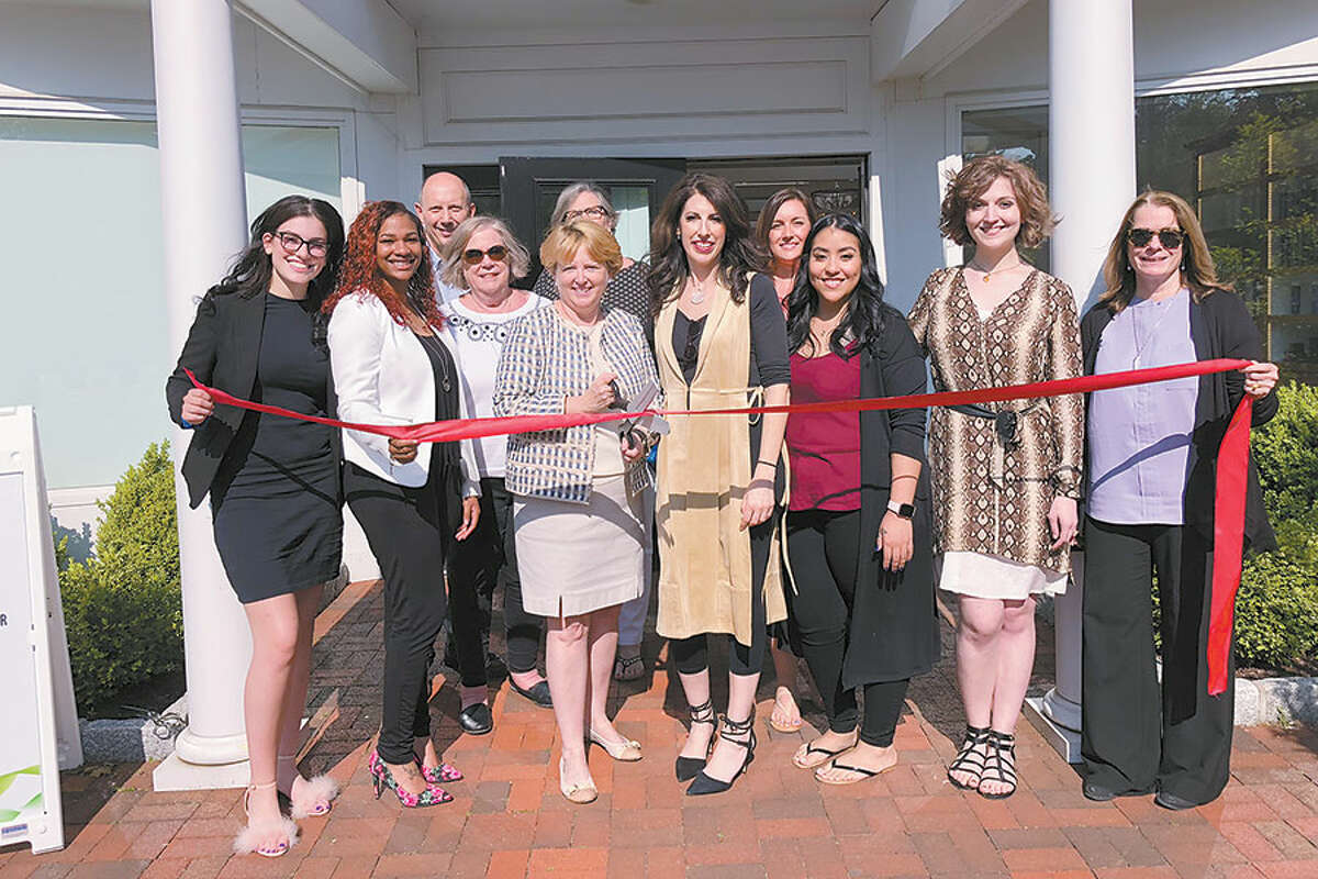 Celebrating the grand opening of the Eco Chic salon are, in front from left, stylists Elizabeth Murphy and Casey Eaton, First Selectwoman Lynne Vanderslice, salon owner Michele Maestri-Murphy, stylists Lucy Reyes and Ann Labine, and Susan Goldman, Chamber president. In back are Chamber members John DiCenzo, Judy White and Peg Koellmer, and stylist Liz Anderson. — Contributed photo