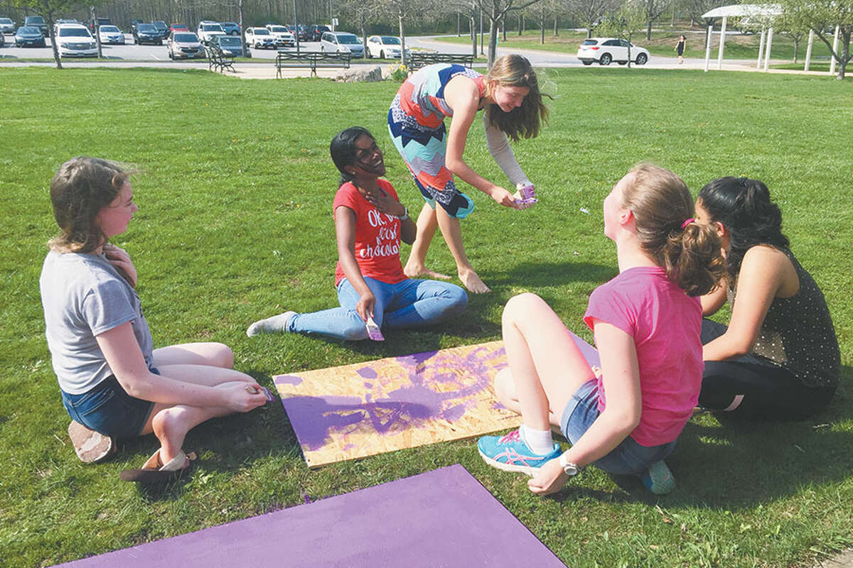 Relay Club members make signs for the upcoming Wilton Relay for Life outside Middlebrook School. — John Priest photo