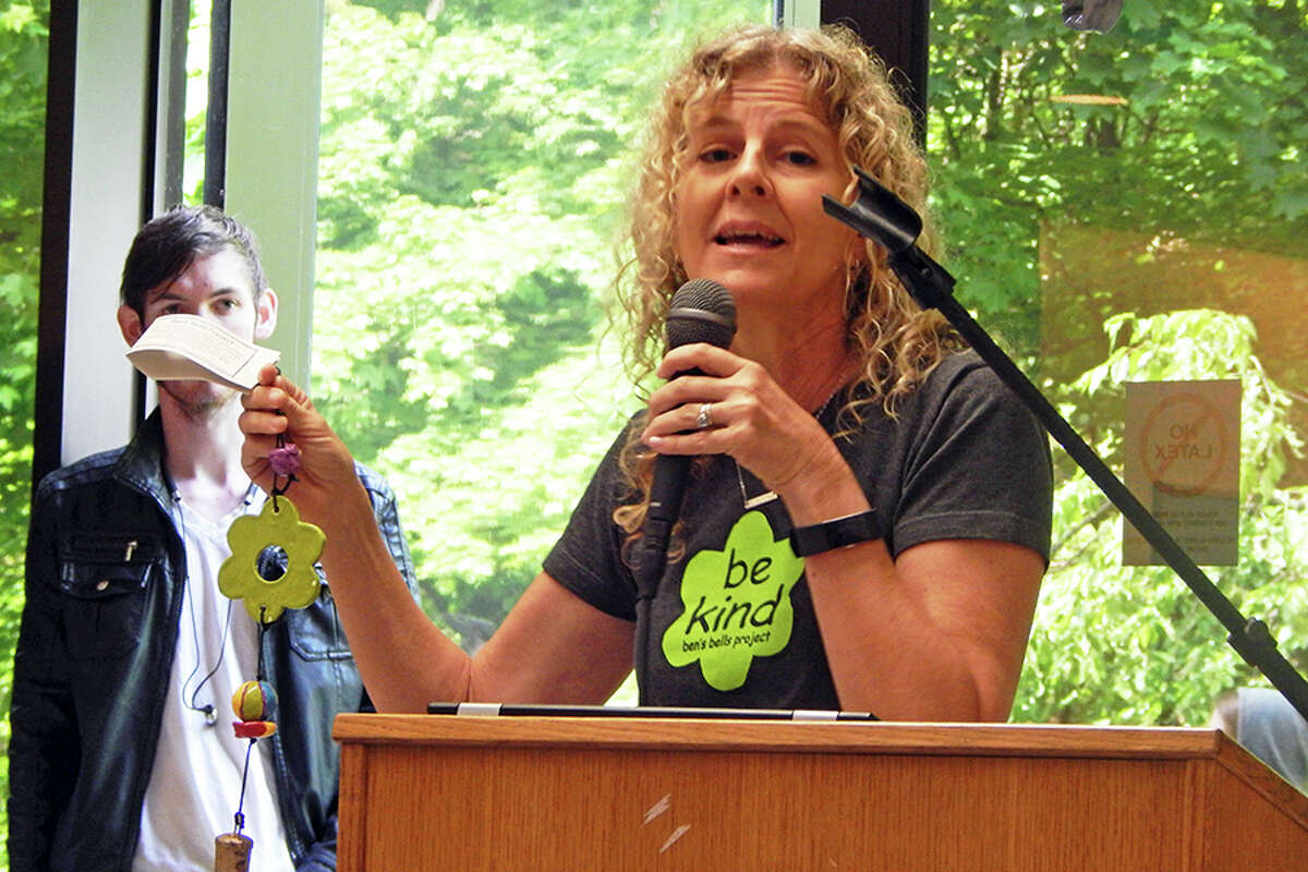 Ben's Bells Project founder and executive director Jeannette Maré holds a Ben's Bell while speaking to students at Wilton High School.