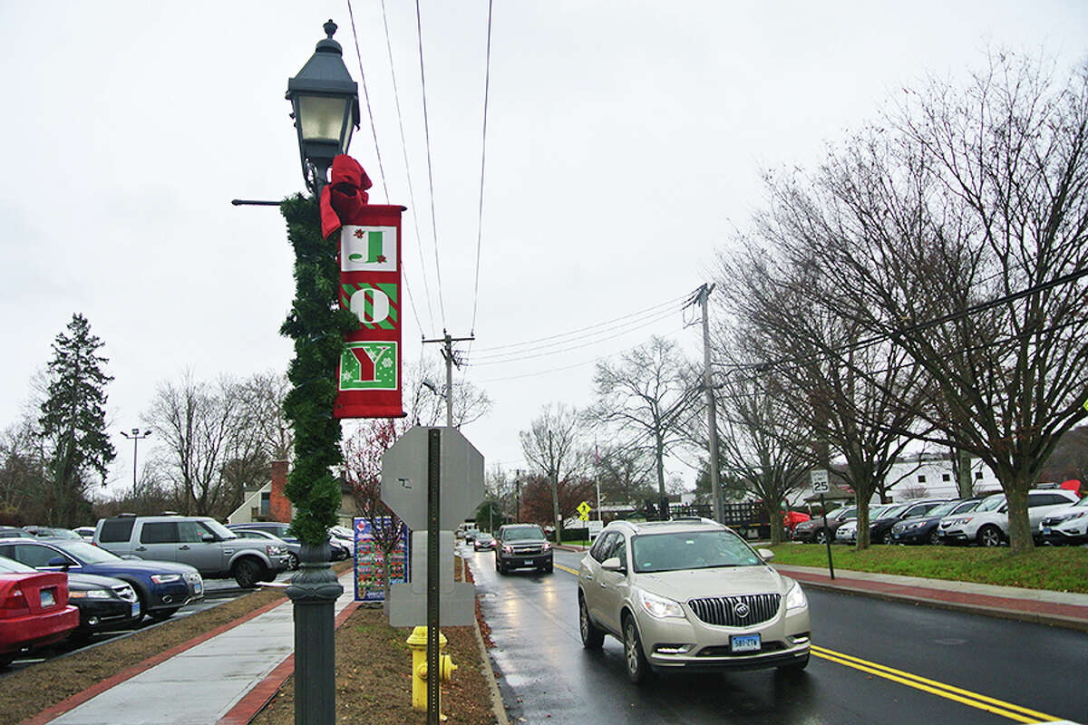 The group Enlighten Wilton would like to bring back the red-and-green Joy banners to replace the blue-and-white snowflake banners introduced during the winter holiday season in 2016.