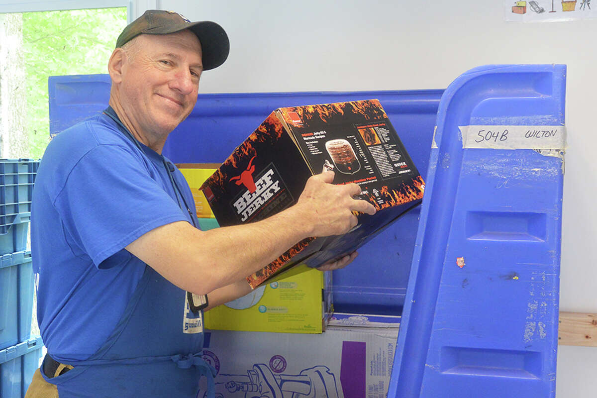 Goodwill donation center attendant Paul Bender of Trumbull loads a bin at the new Goodwill of Western and Northern Connecticut donation station on Danbury Road. — Tony Spinelli photo