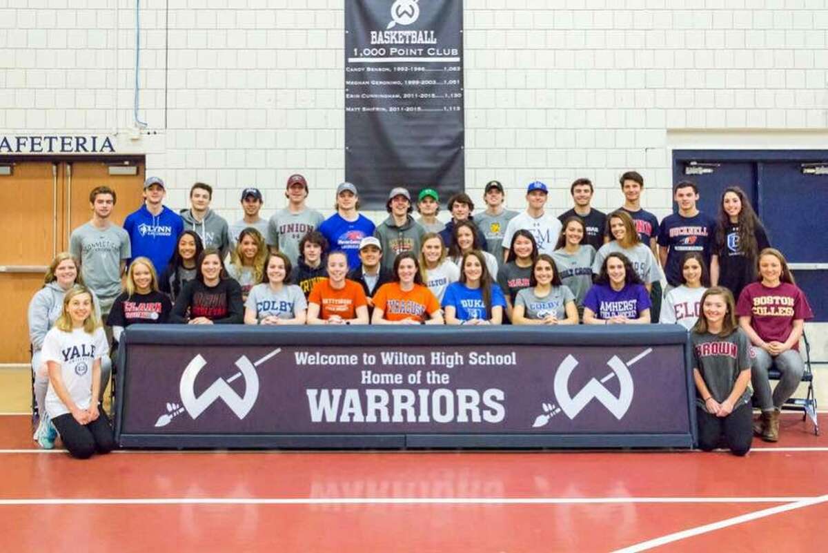 Wilton High senior athletes who will play on the collegiate level next school year. Front row, kneeling: Morgan McCormick (left) and Emma Rosen (right); front row, seated: Claire Gulbin, Sophie Phelan, Taylor Floyd, Molly Thomas, Madeline Pagliaro, Bella Fox, Eva Greco, Zoe Lash, Sophia Kaplan, Paige Brown and Paisley Eagan; middle row: Lelah Conway, Sophia Mercado, Finn McGovern, Jack DiNanno, Emmy Goodwin, Mackenzie Cote, Lacey Eller, Julia Bonnist and Jessica Hendry; back row: Jake Florio, Jake Oliver, Nolan Quinn, Chris Colbert, Robbie Hermann, Zach Zeyher, Joe Scarfi, Joe Murtha, Brian Calabrese, Scott Cunningham, Ryan Gabriele, Dillon Lifrieri, Ethan Reichgut, Jack Lewis and Megan Lynch. — GretchenMcMahonPhotography.com