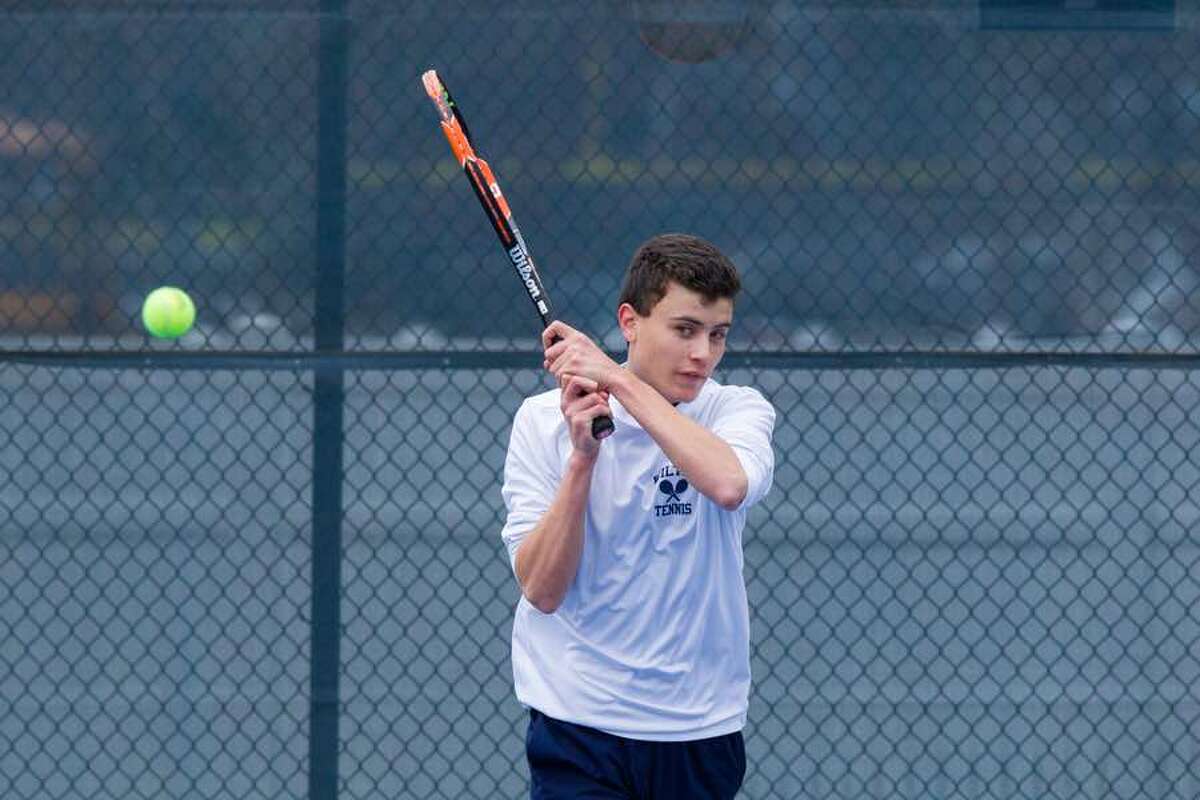 Number-one singles player Clay Adams hits a return in recent Wilton High boys tennis action. — GretchenMcMahonPhotography.com