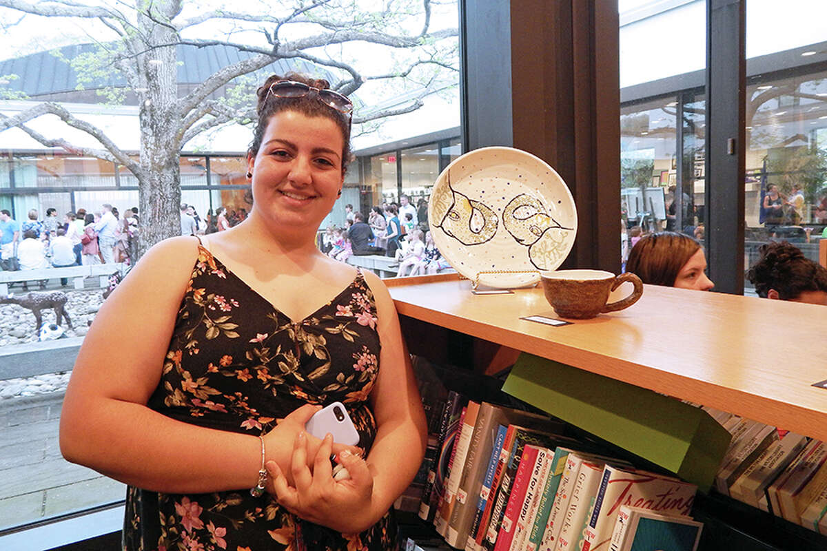 Wilton High School student Julianna Russo stands next to her ceramic plate featured in Wilton Schools FAPA Exhibit.