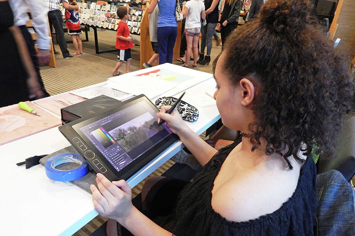 Middlebrook eighth grader Danielle Coltman creates art on a tablet during the opening reception of the FAPA Exhibit.