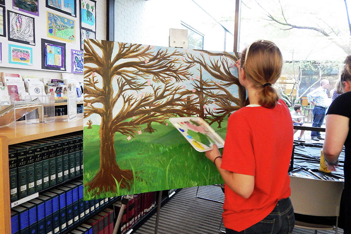 Wilton student paints during the FAPA Exhibit opening reception.
