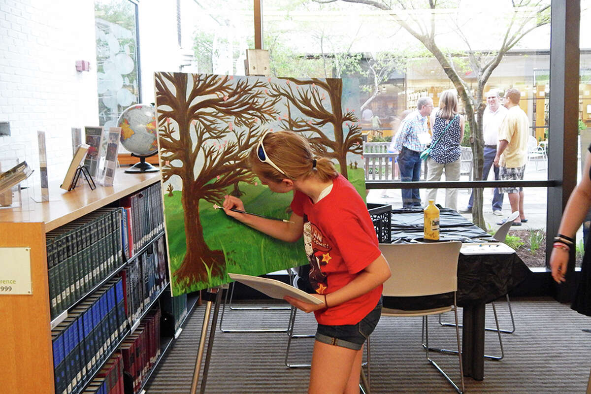 Wilton student paints during the FAPA Exhibit opening reception.