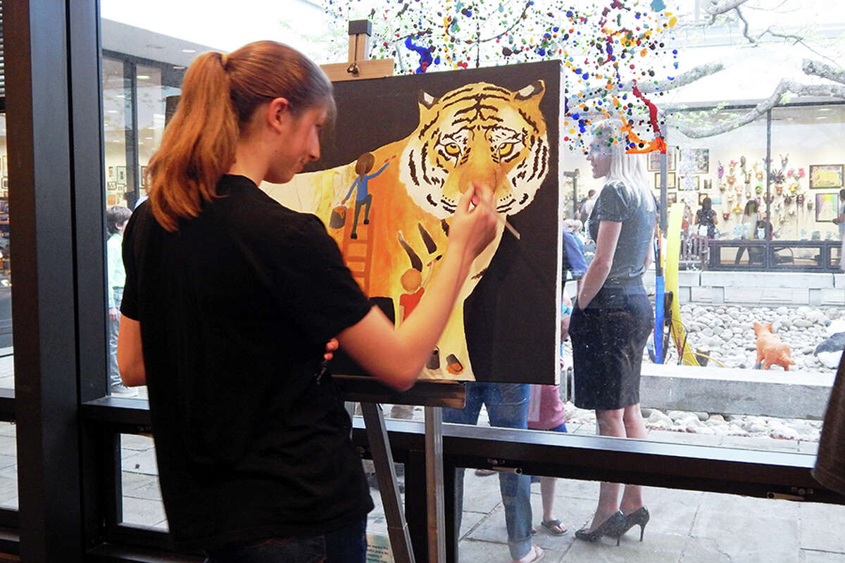 Wilton student paints during the FAPA Exhibit opening reception.