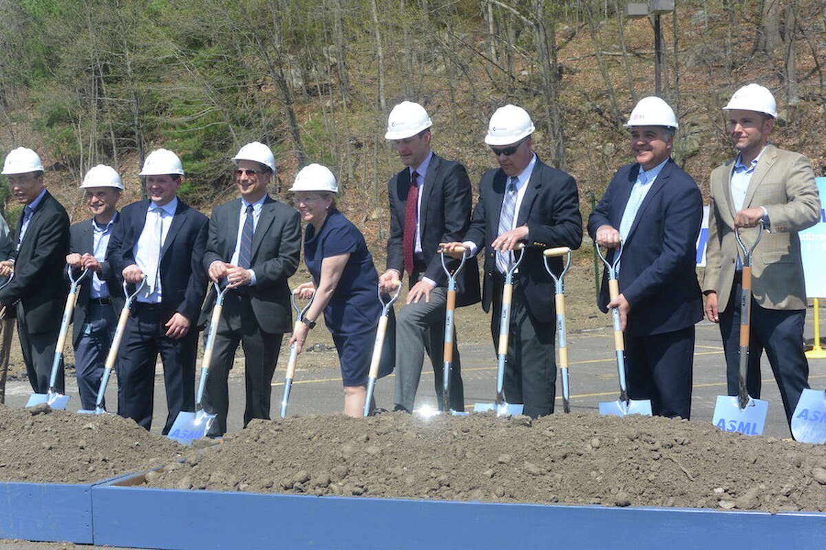 First Selectwoman Lynne Vanderslice and U.S. Rep Jim Himes, center, dig with shovels among others at the groundbreaking for ASML’s parking garage. —Tony Spinelli photo.
