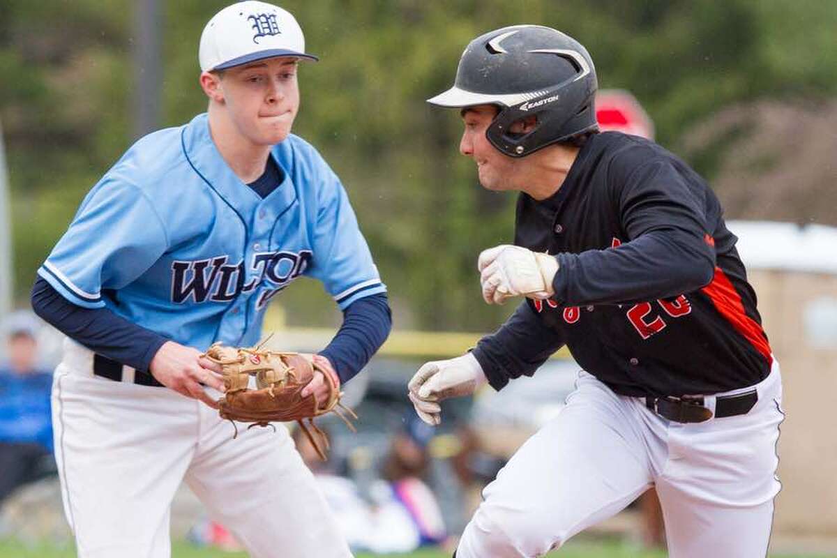 Ethan Leinberger tries to put the tag on a Ridgefield base runner during the Wilton baseball team's game at home on Monday. — GretchenMcMahonPhotography.com