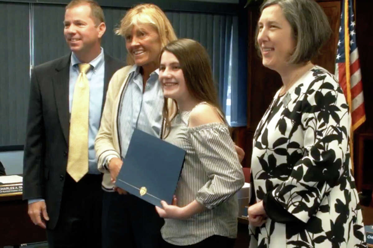 Sloan Barker accepts her award from Superintendent Kevin Smith, Board of Education Chair Christine Finkelstein and Middlebrook Principal Lauren Feltz.