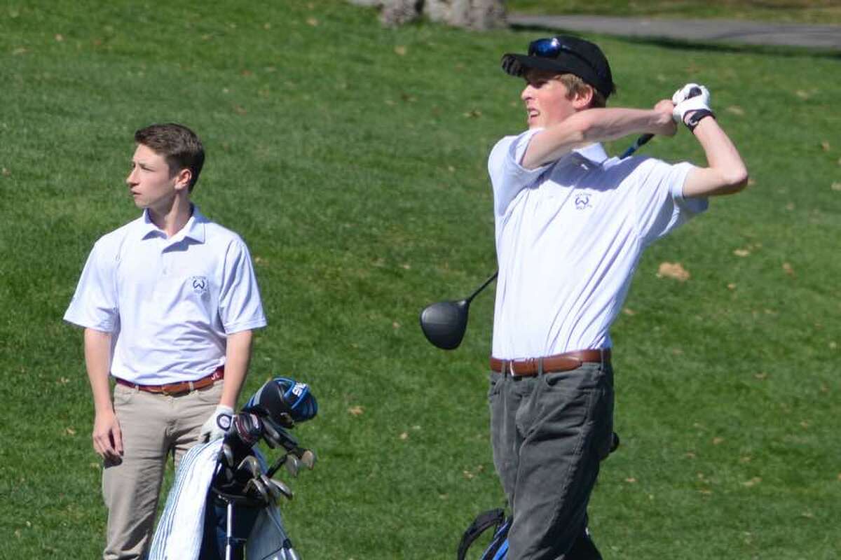 Will Kalin (left) and Jack Cromwell watch the flight of Cromwell's tee shot during the Wilton boys golf team's match on Monday at Rolling Hills Country Club. — J.B. Cozens photo
