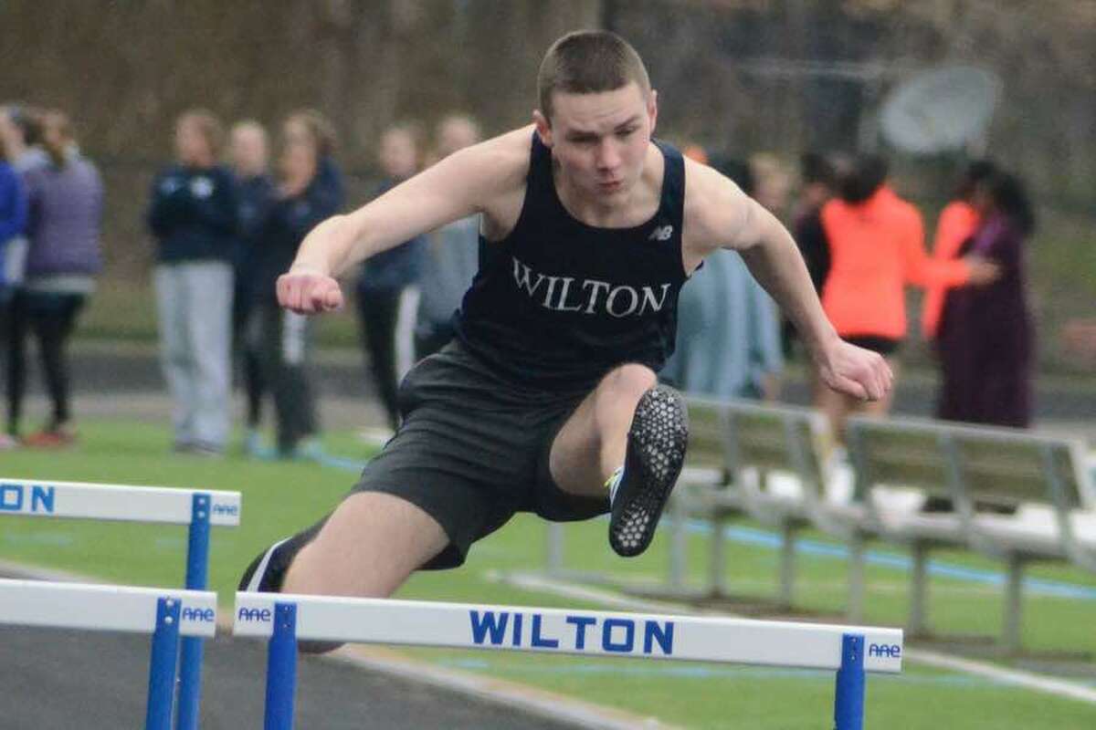Richard Dineen competes in the 110-meter hurdles for the Wilton boys track and field team during its meet on Tuesday at home. — J.B. Cozens photo