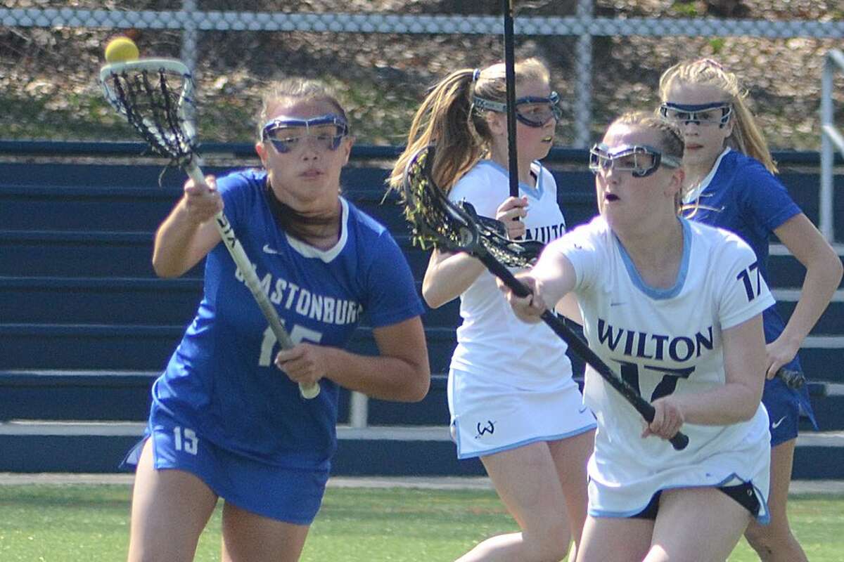 Emmy Goodwin puts the pressure on Glastonbury's Leah Suydam during the Wilton girls lacrosse team's win on Saturday. — J.B. Cozens photo