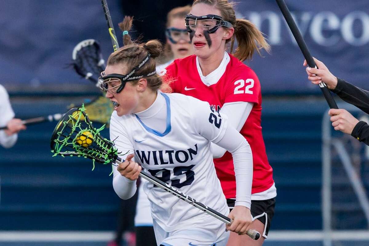 Paisley Eagan goes on the attack during the Wilton girls lacrosse team's game against New Canaan last week. — GretchenMcMahonphotography.com