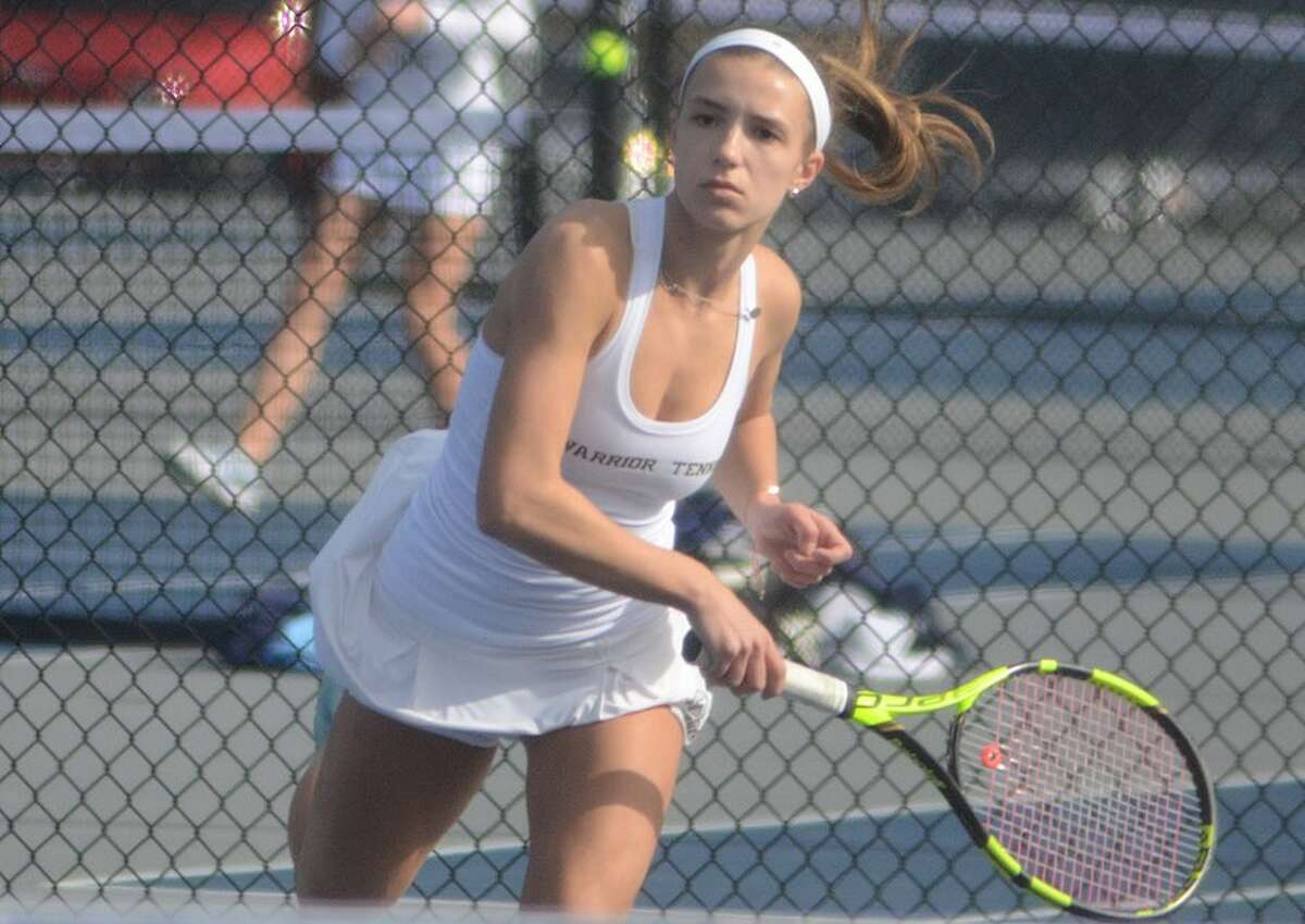 Izzy Koziol hits a winner during her win at first singles on Monday against Staples. — J.B. Cozens photo