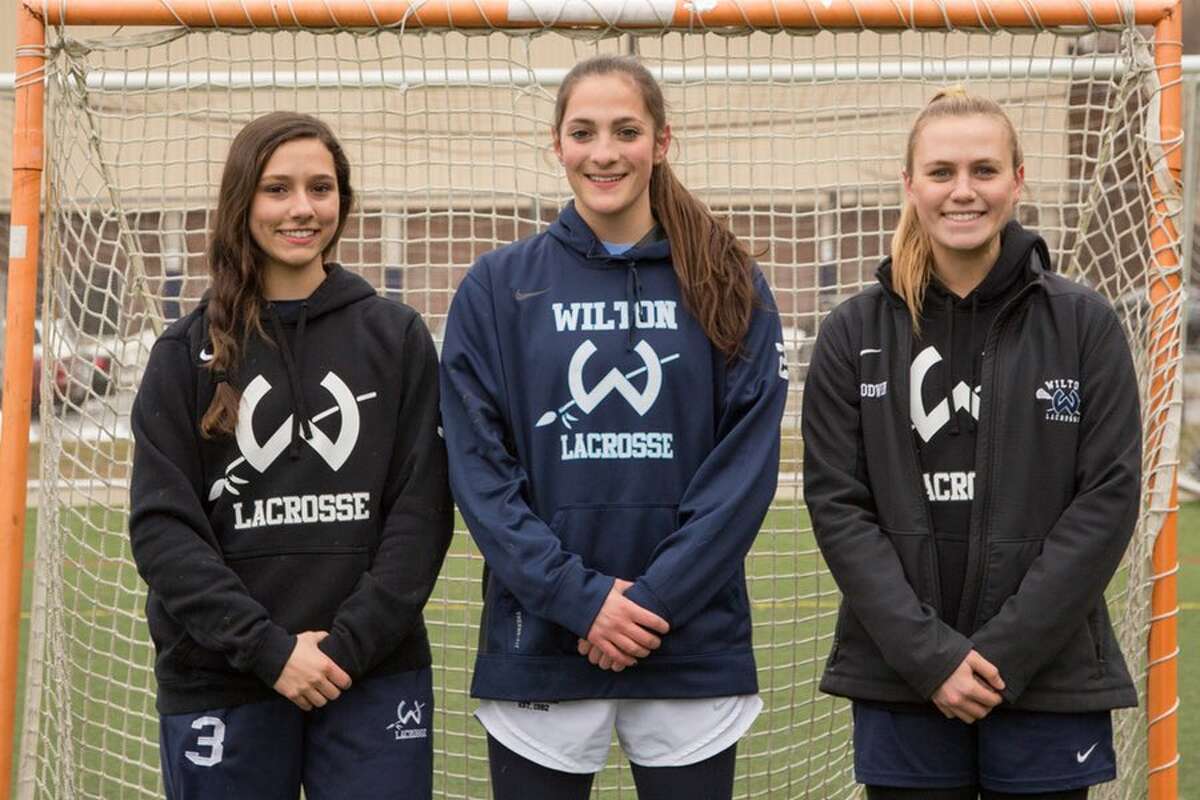 Captains of this year’s Wilton High girls lacrosse team are, from the left: Paige Brown, Eva Greco and Emmy Goodwin. — GretchenMcMahonPhotography.com