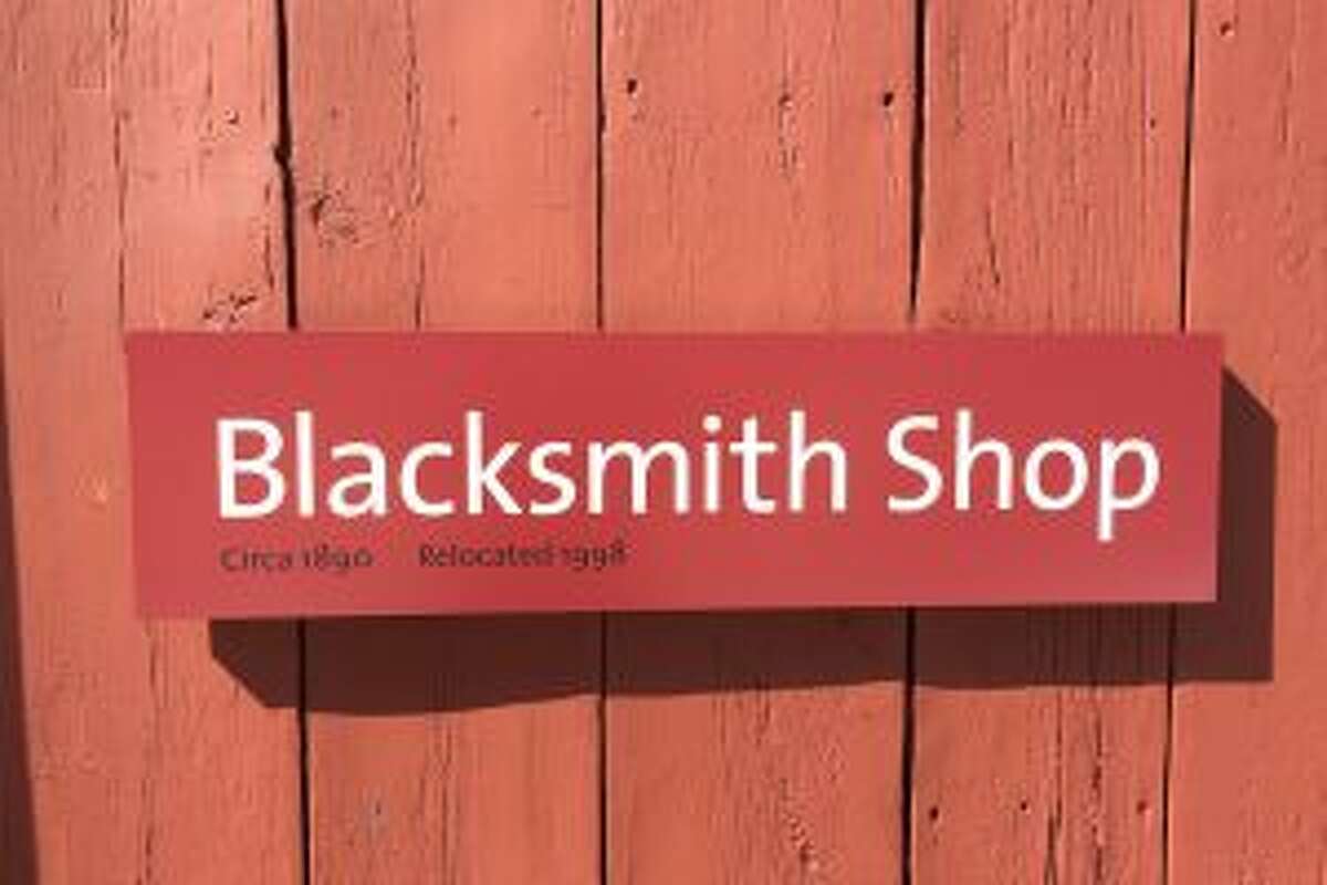 The sign indicating the Blacksmith Shop at the Wilton Historical Society's museum complex is discreet and complement the building's color.