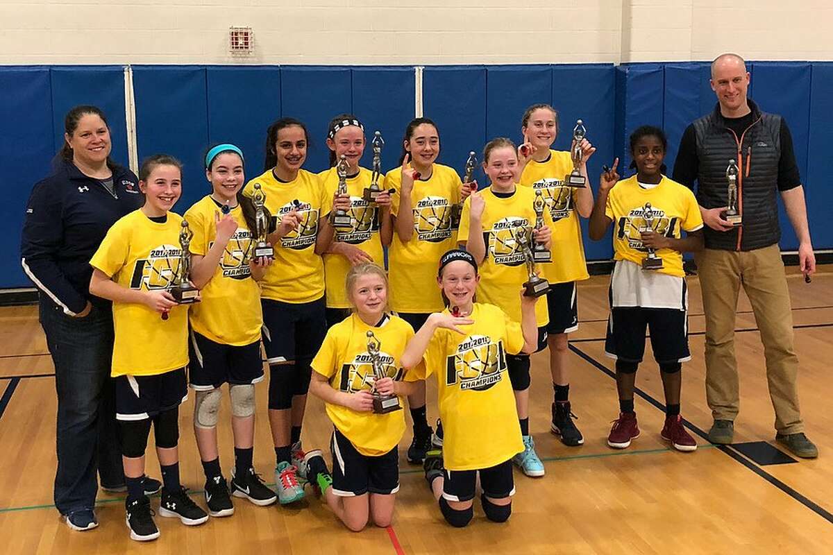 The Wilton sixth grade girls basketball team after winning its second consecutive county ‘A’ division title. From the back left, clockwise: coach Cricket Luke, Marin Burke, Molly Hancock, Caroline Hage, Lauren Moe, Ella Mulfinger, Maddie Dineen, Ashleigh Masterson, Anisa Burrows, coach Dorian Melkonian, Riley Fitzgerald, and Julie Collias.