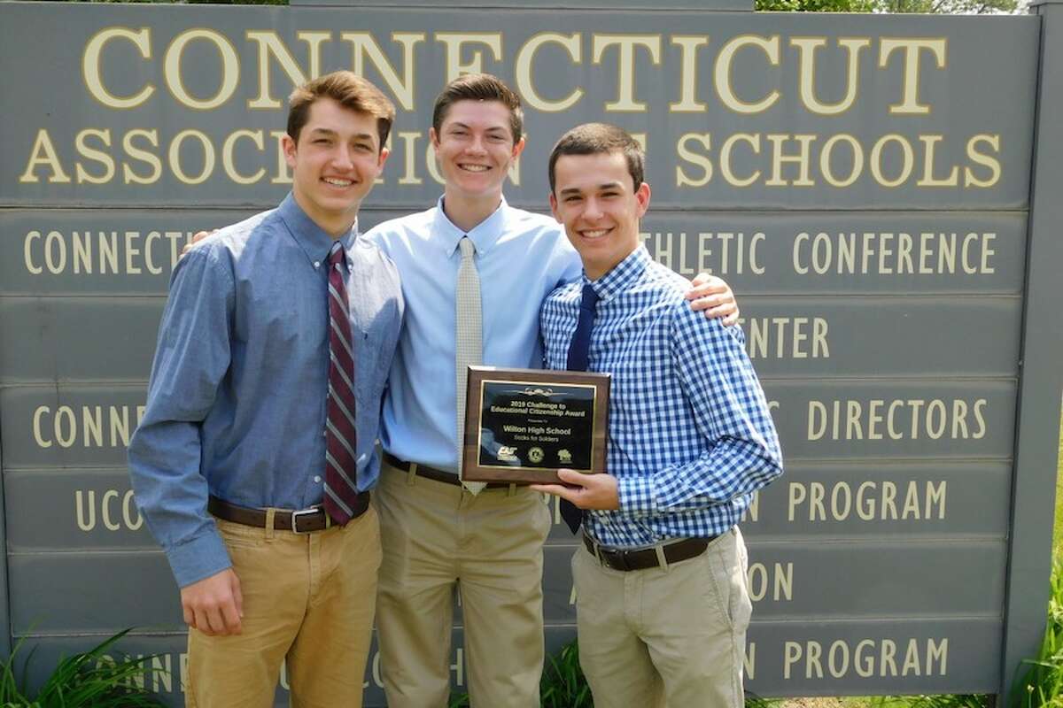 From left, Jake Zeyher, Kace Stewart, and Connor Burke are at the Connecticut Association of Schools in Cheshire to receive an award for Sock for Soldiers program on June 5.