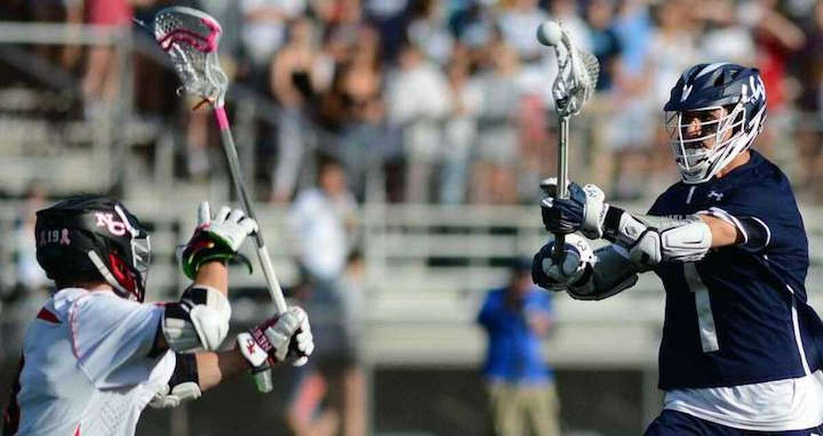 Wilton's Dean DiNanno fires a shot during the FCIAC boys lacrosse championship game. — Erik Trautmann / Hearst Connecticut Media