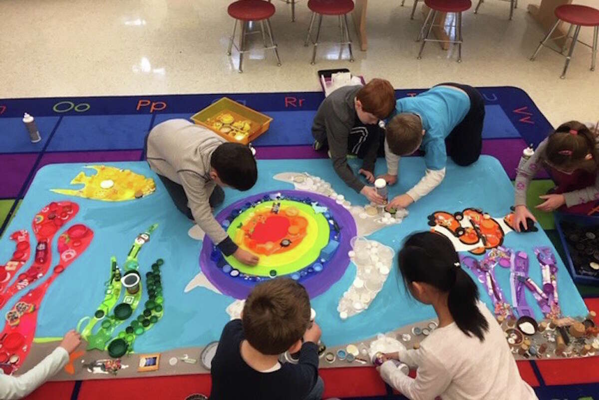 Miller-Driscoll students work on a mural using recyclable materials. — Contributed photo