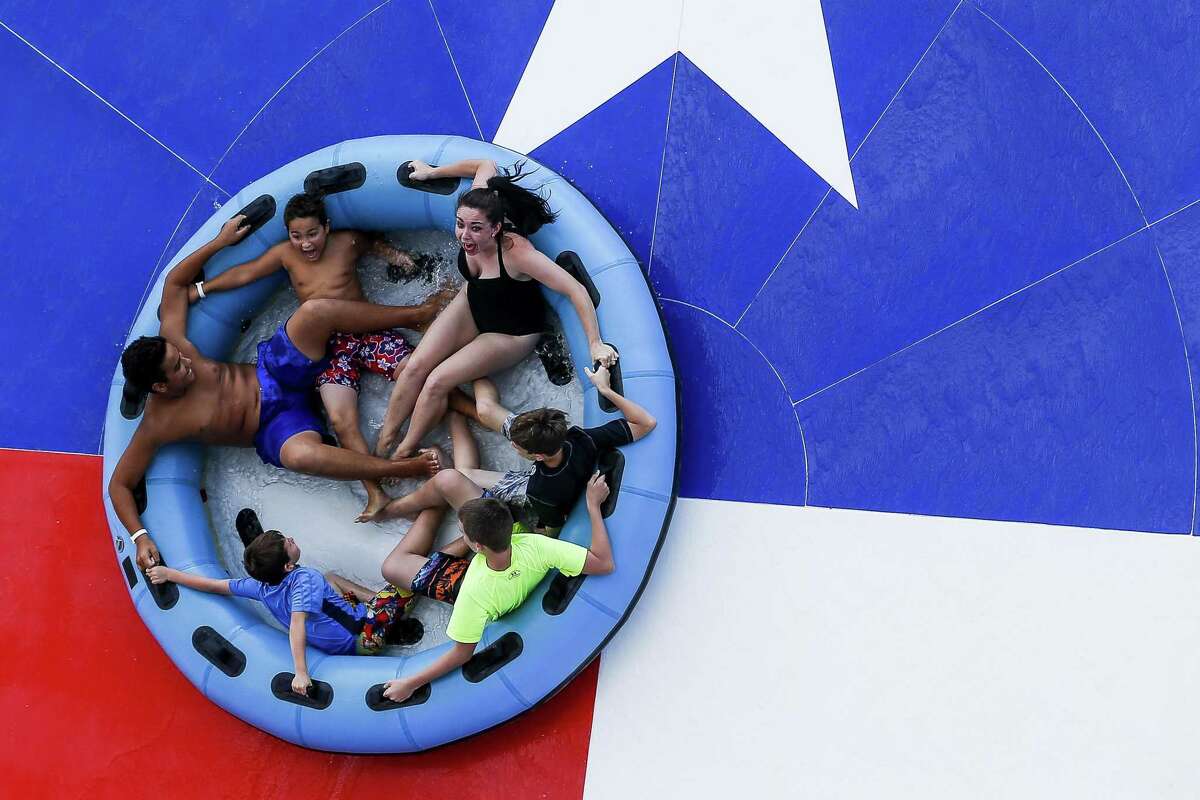 People laugh and scream as they reach the star of The Typhoon slide at Typhoon Texas where the water park is celebrating Christmas in July all week Wednesday July 25, 2018 in Katy. (Michael Ciaglo / Houston Chronicle)