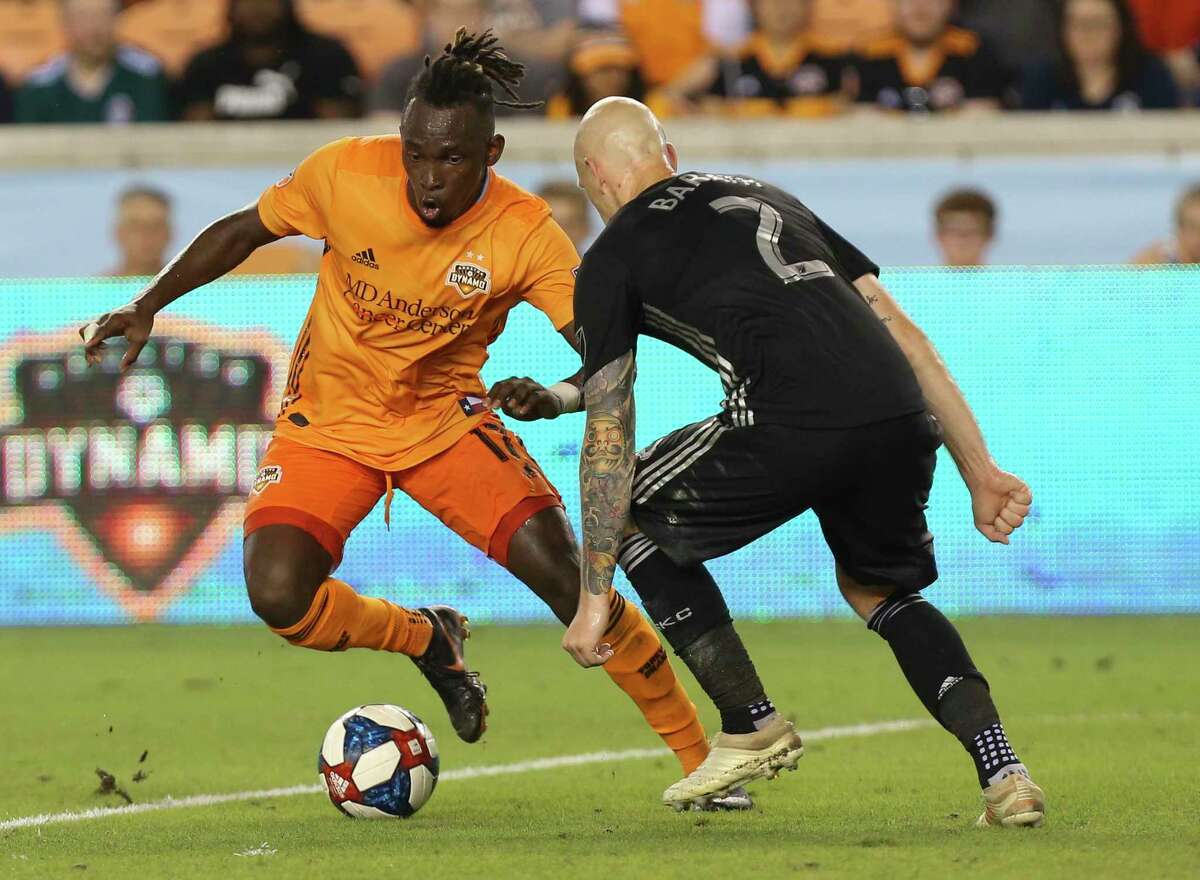 Houston Dynamo forward Alberth Elis (17) dribbles while Sporting Kansas City defender Botond Barath (2) is defensing during the second half of the MLS game at BBVA Compass Stadium on Saturday, June 1, 2019, in Houston. The Houston Dynamo tied with Sporting Kansas City at 1-1.
