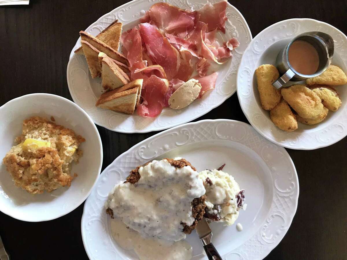 Clockwise from Squash casserole, country ham plate, fried green tomatoes and chicken fried steak from Fontaine's Southern Diner & Bar