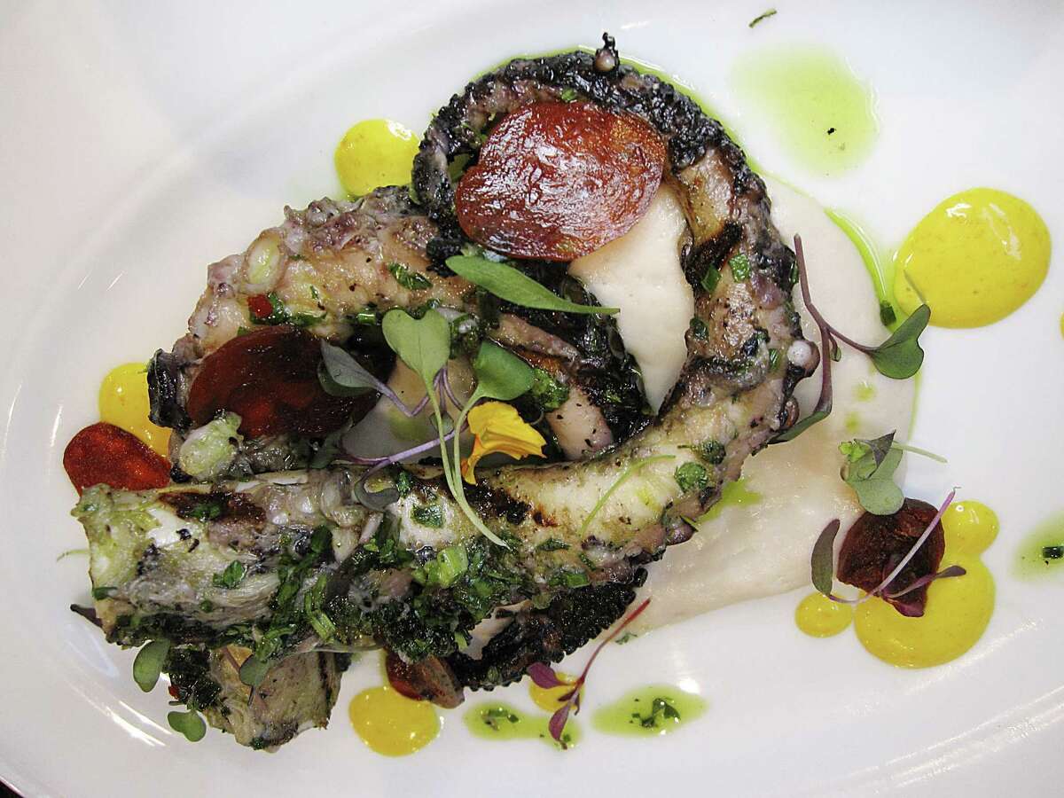 Grilled Spanish octopus is plated with chorizo, cannellini bean puree, chimichurri and saffron lemon sauce at Mako's on the Creek in Cibolo.